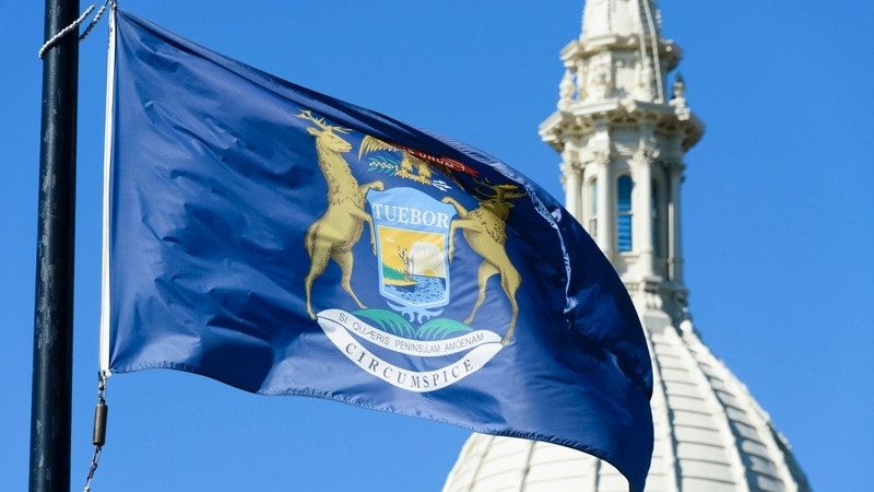 Michigan flag in front of Capital Building