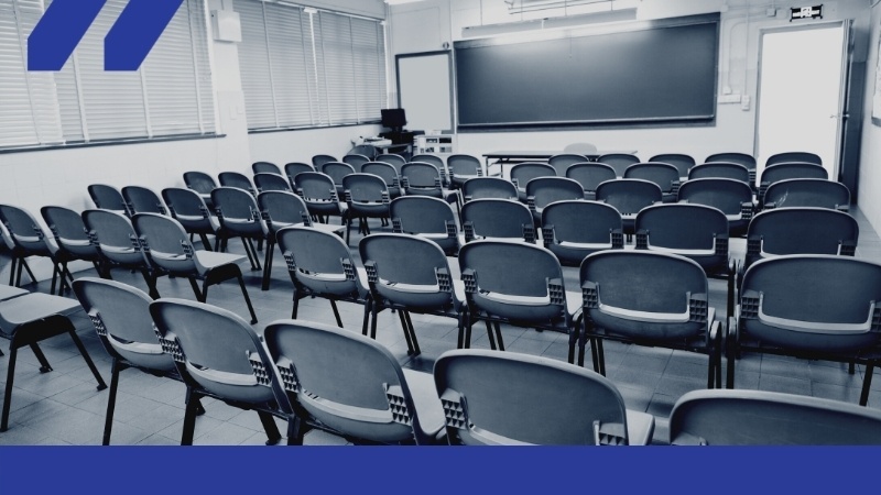 Image of a college classroom full of empty chairs.