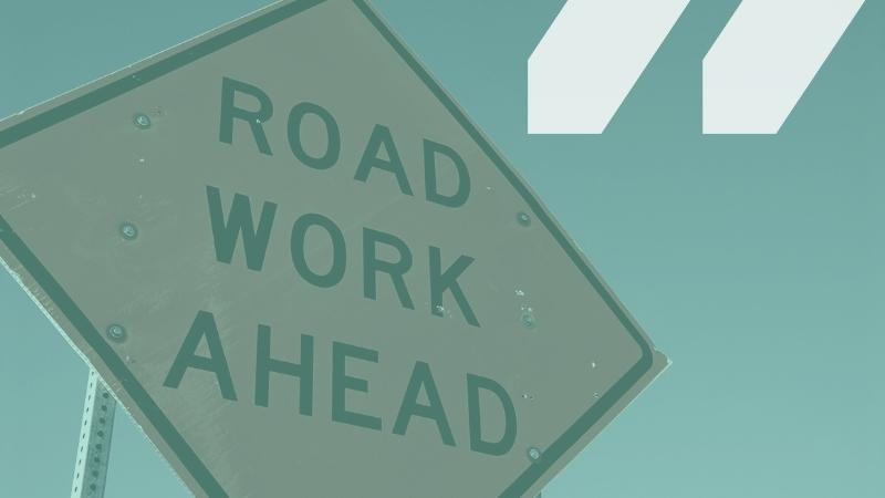 Image of a road work sign that reads Road Work Ahead