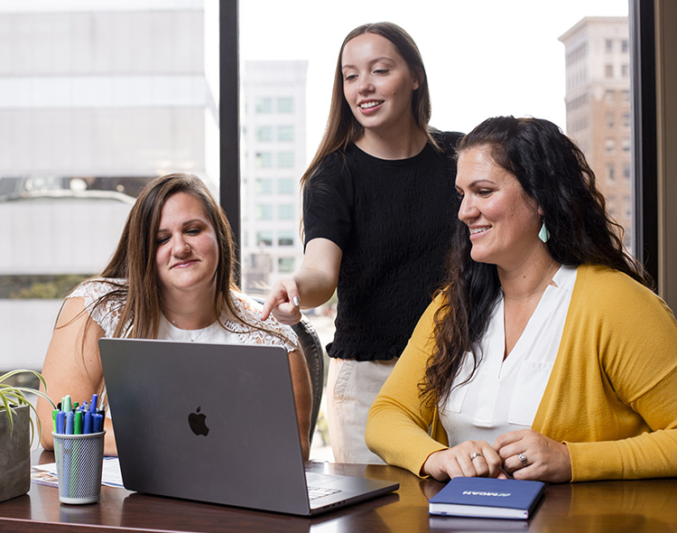 3 people talking in an office environment