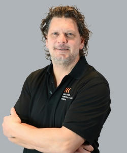 Todd Wozniak wearing a black polo shirt